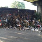 Lorry overturns on A13 slip road with tonnes of  rubbish covering car park