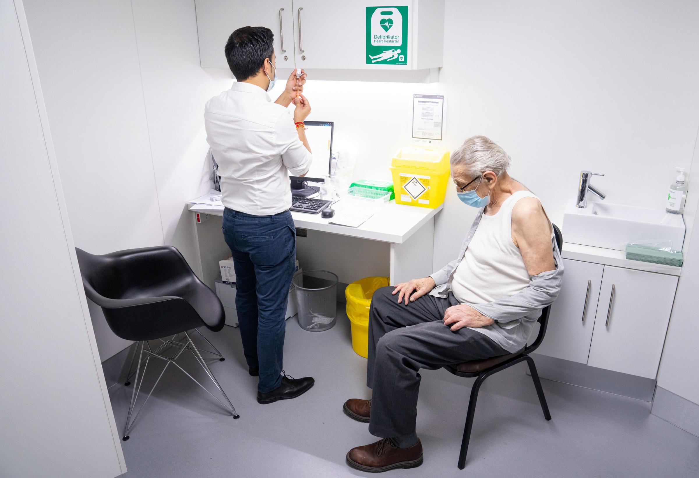 Pharmacist Bhaveen Patel prepares to give a dose of the Oxford / AstraZeneca covid vaccine to Brian Bourne at a coronavirus vaccination clinic held at Junction Pharmacy in Brixton, London. The roll out of the vaccination programme continues as the Governm