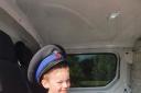FUTURE OFFICER: Young James trys on PCSO Endersby's hat