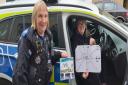 SPECIAL DAY: Elise presents her drawings to an officer from the Harwich Community Policing Team