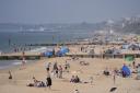 People enjoying the sunny weather on Boscombe Beach in Bournemouth, Dorset (Andrew Matthews/PA)