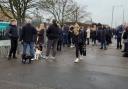 Parents wait anxiously outside Ortu Gable Hall School as police were called in to a hoax threat.