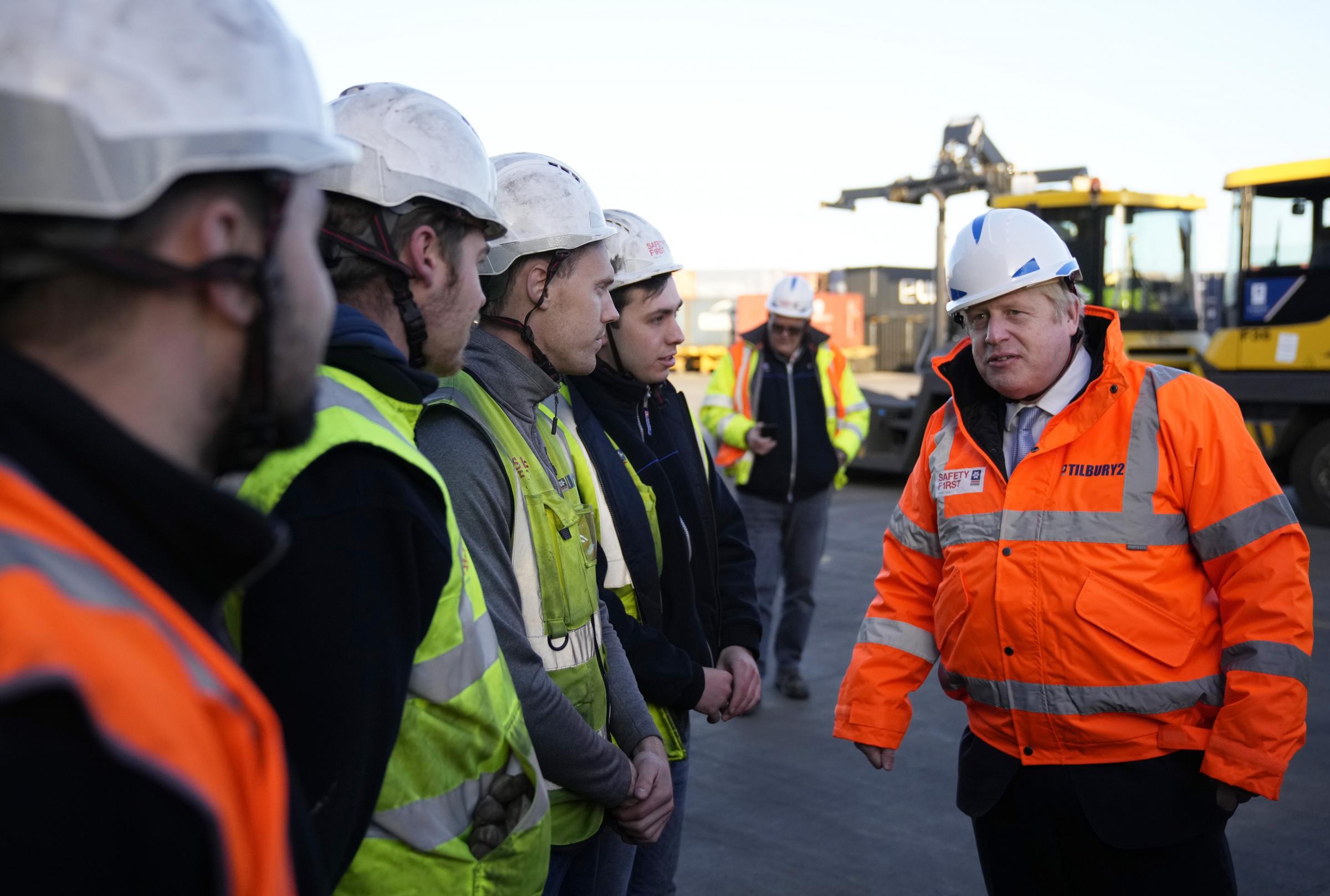 Prime Minister Boris Johnson speaks with workers during a visit to Tilbury Docks in Essex. Picture date: Monday January 31, 2022.