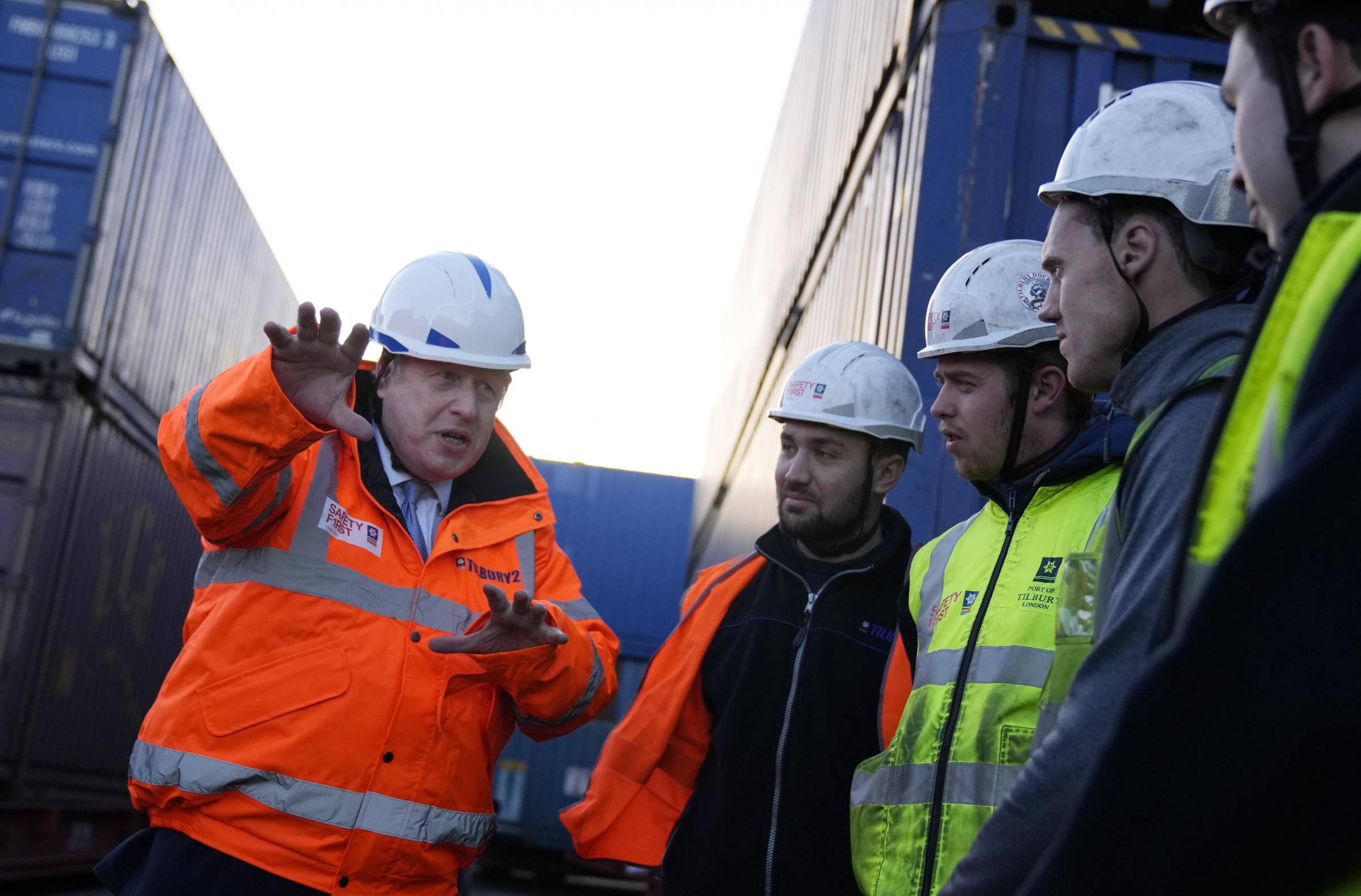Prime Minister Boris Johnson speaks with workers during a visit to the Tilbury Docks in Essex. Picture date: Monday January 31, 2022.