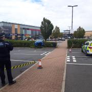 Man held on suspicion of attempted murder after car's driven at group at night hotspot