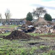 Huge piles of rubble are left at cemetery sparking community fury